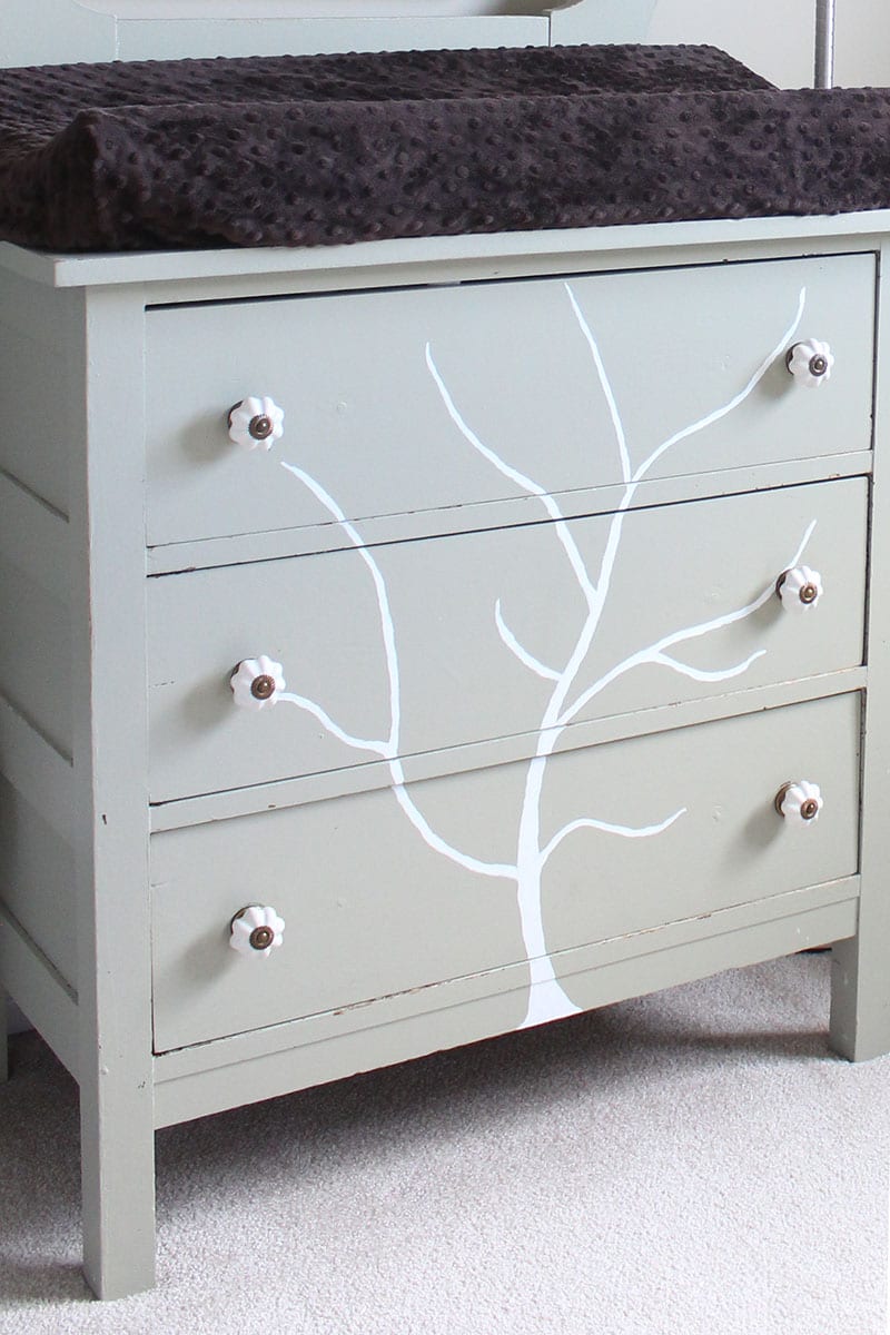 A handpainted tree dresser used as a change table.