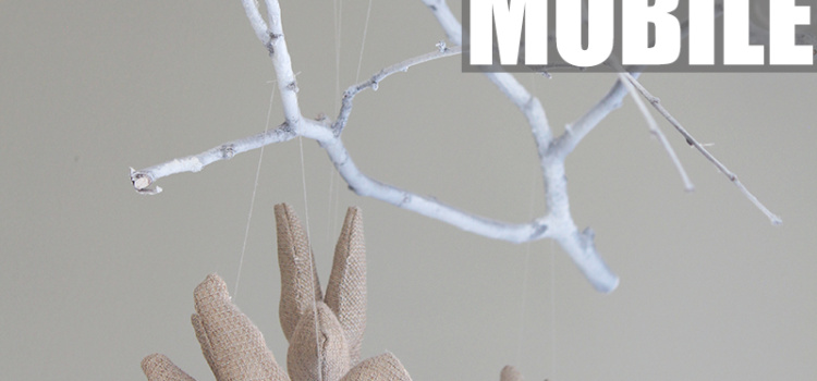 Super charming and whimsical DIY tree branch mobile made with a spray-painted poplar branch, stuffed birds and fishing line.