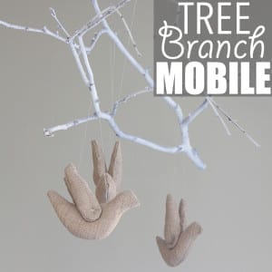 Tree Branch Mobile by Of Houses and Trees | Super charming and whimsical DIY tree branch mobile made with a spray-painted poplar branch, stuffed birds and fishing line.