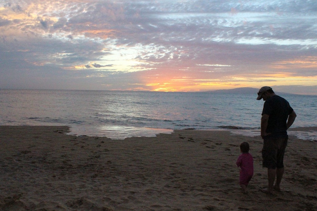 Father and daughter watching the sunset during our Maui family vacation.