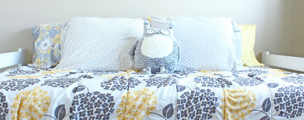 Yellow Toddler Bedroom | Welcome to our yellow toddler bedroom. Featuring grey and white accents and an owl motif. This room is a super happy fun place for a cute and quirky kid!
