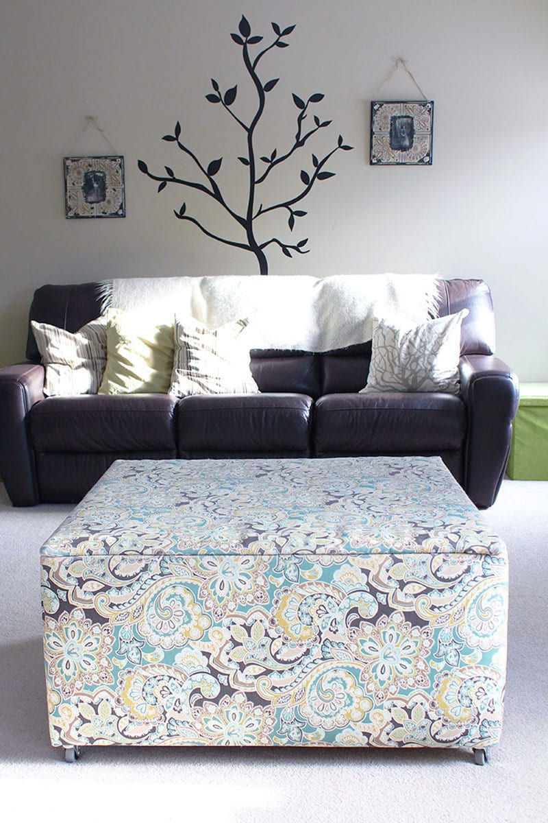 A wood ottoman toy box covered in a graphic floral print.