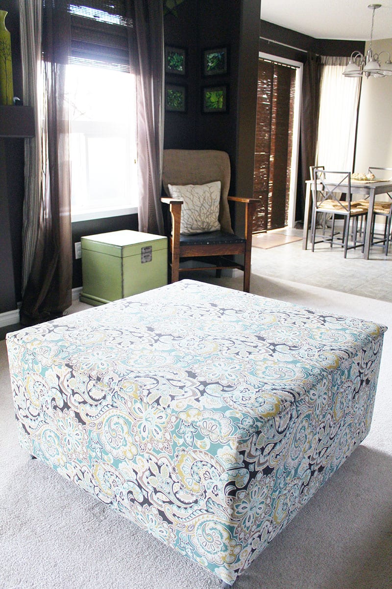 A wood ottoman toy box covered in a graphic floral print.
