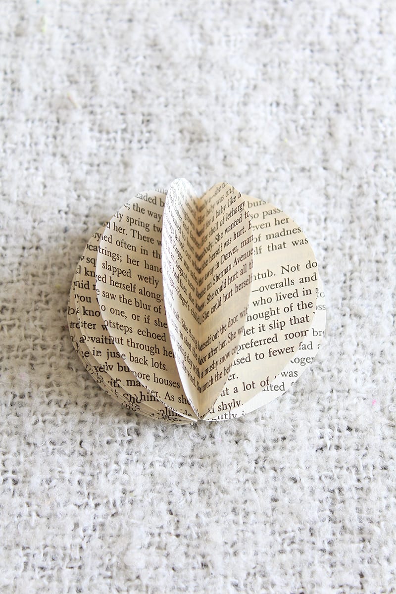 How to make a paper orb from old book pages. Step 4: Use the glue stick to begin gluing the outsides of the folded circles together, working all the way around until you glue the first folded circle with the last. Tip: If you're planning on setting the orb out on a flat surface, fold the orb flat and snip a tiny sliver off the bottom to give it a straight edge.