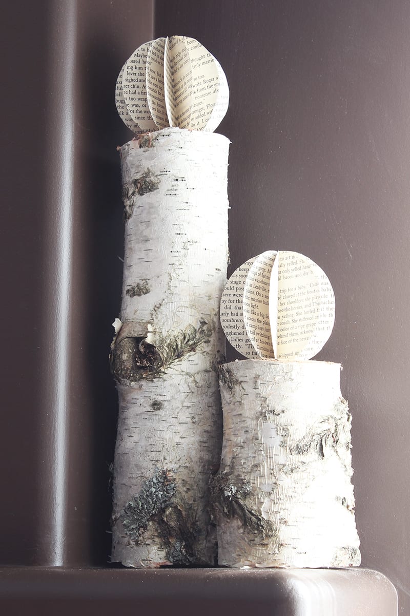 The more refined look of these book page paper orbs goes perfectly with rustic birch logs.