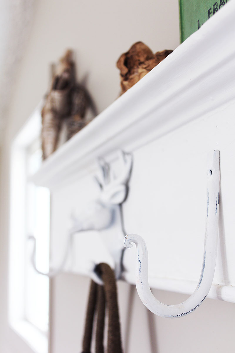 Want to create a unique place to hang your stuff? Grab an antique header, throw on some metal hooks and you've got yourself a DIY wall mounted coat rack!