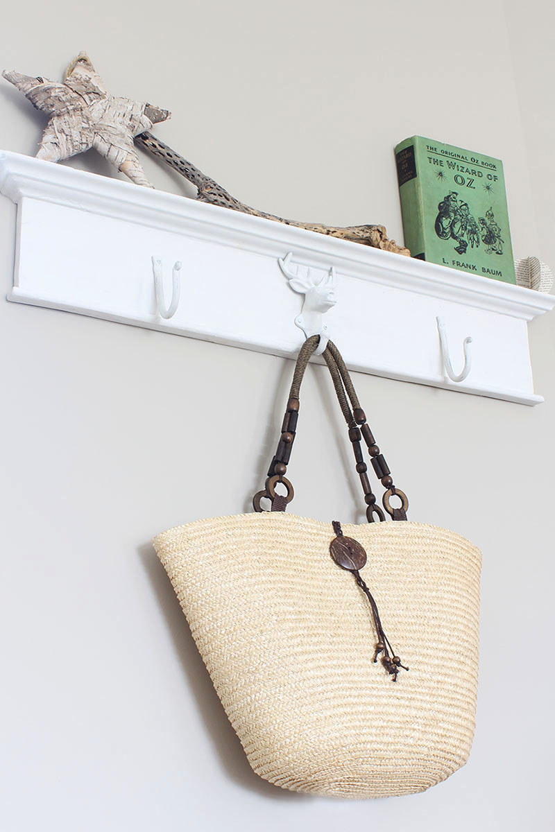 Want to create a unique place to hang your stuff? Grab an antique header, throw on some metal hooks and you've got yourself a DIY wall mounted coat rack!