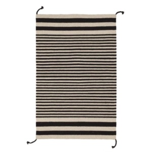 Here's how to create a modern boho living room, which balances the funky boho vibe with clean lines and neutral colours - and features beautiful decor like this cozy minimalist area rug.