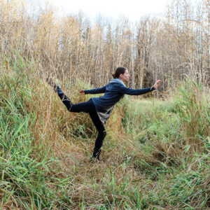 Larissa dancing in a field during the fall.