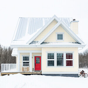 A yellow house in winter.