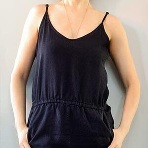 A woman wearing a black jumpsuit. Click to visit post.