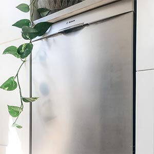 Closeup of a stainless steel dishwasher.