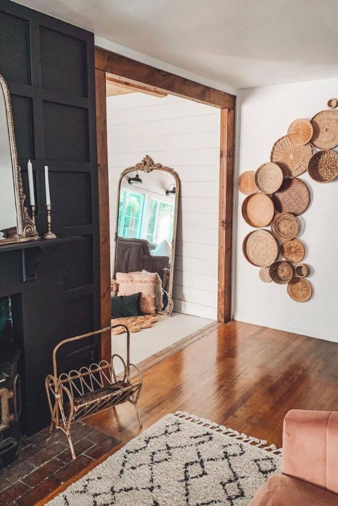A grouping of baskets on a wall in a cozy living room.
