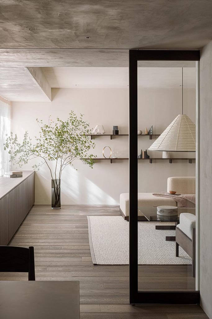 Japandi living room with a black sliding pocket door.