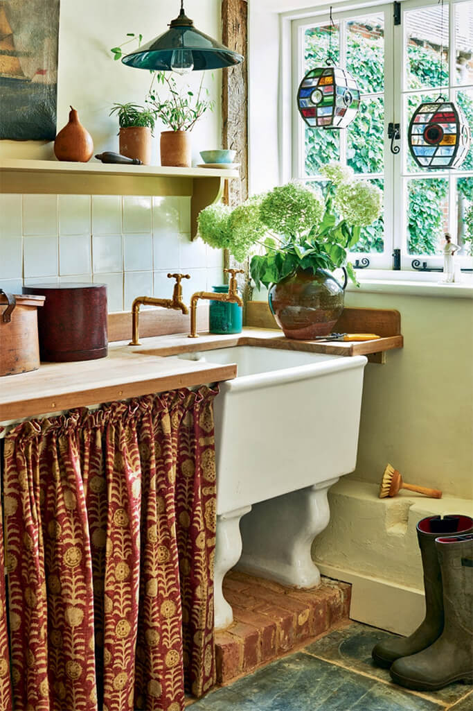 A vintage white sink set into a wooden countertop.