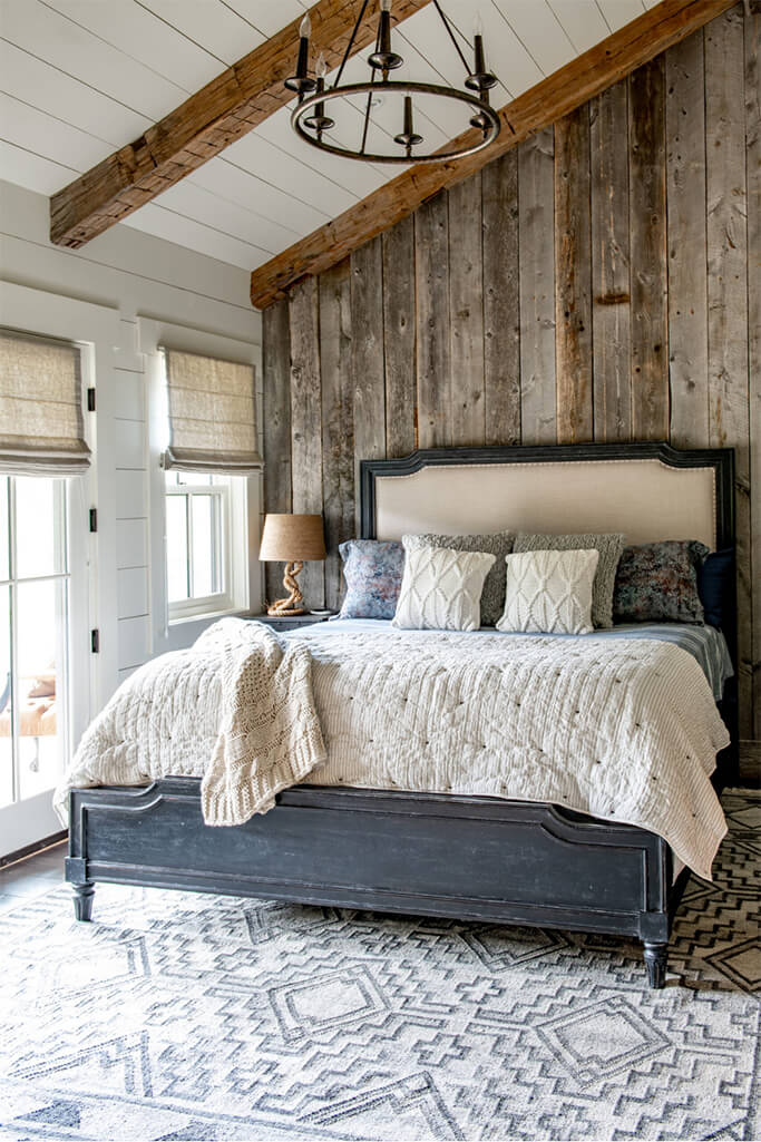 A farmhouse-style bedroom with a reclaimed wood feature wall.