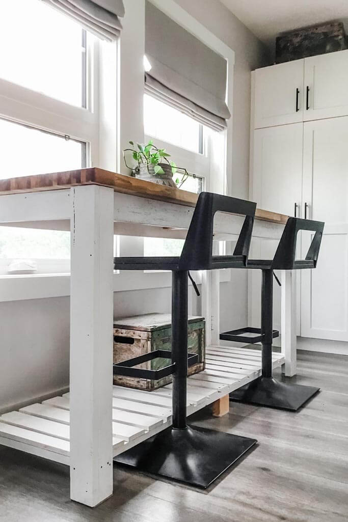 White table with wood top and black metal chairs.