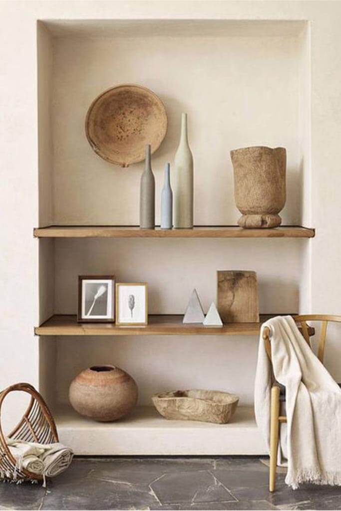 Floating wood shelves lined with rustic accessories.