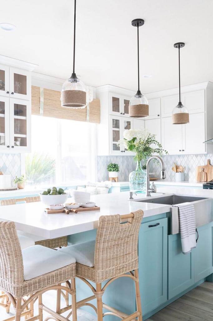 A kitchen with blue cabinets and coastal decor.