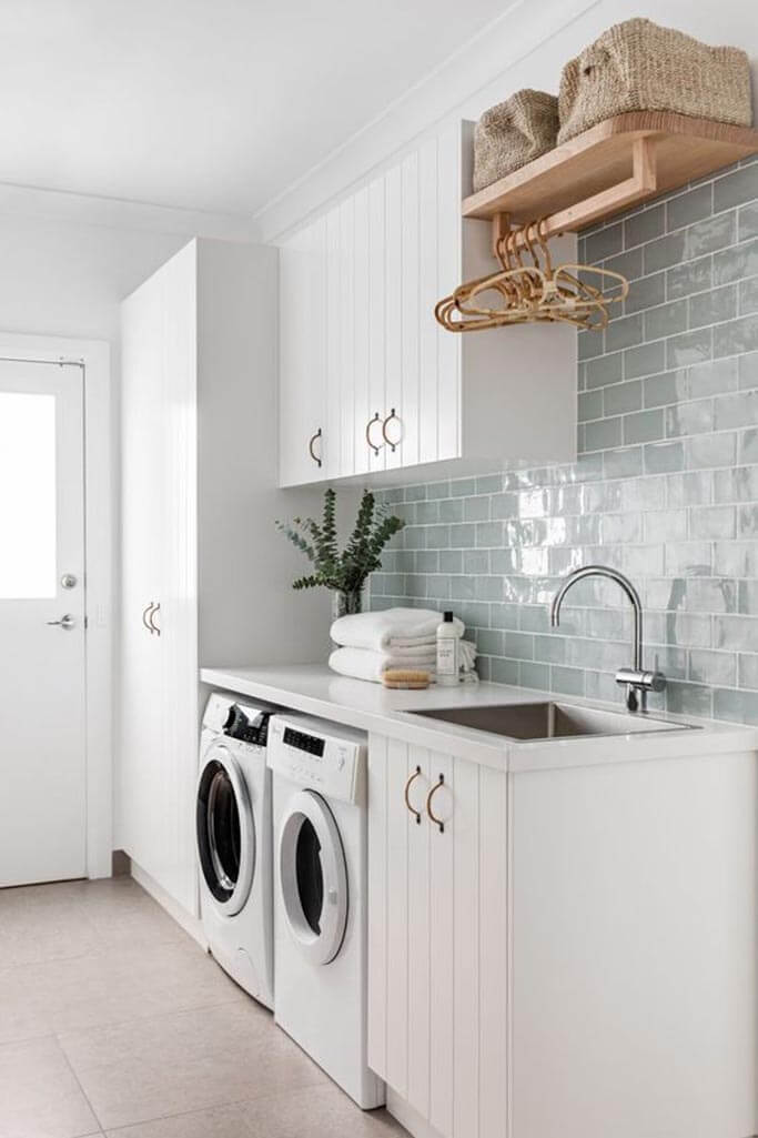 A clean laundry room with a white washer and dryer.