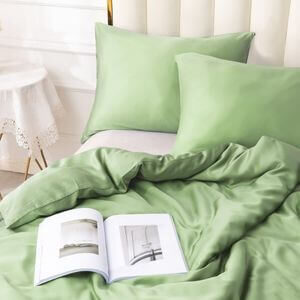 A bed with a bright green duvet set.