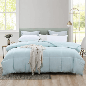 A bedroom with light blue bedding.
