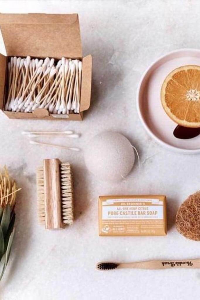 Various zero waste bathroom products on a white-grey background.