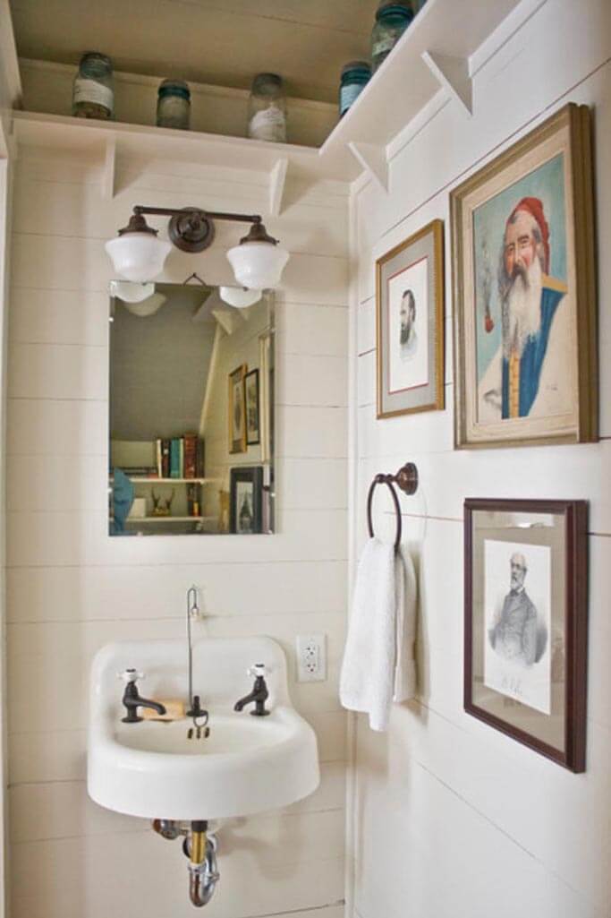A bathroom filled with vintage art.