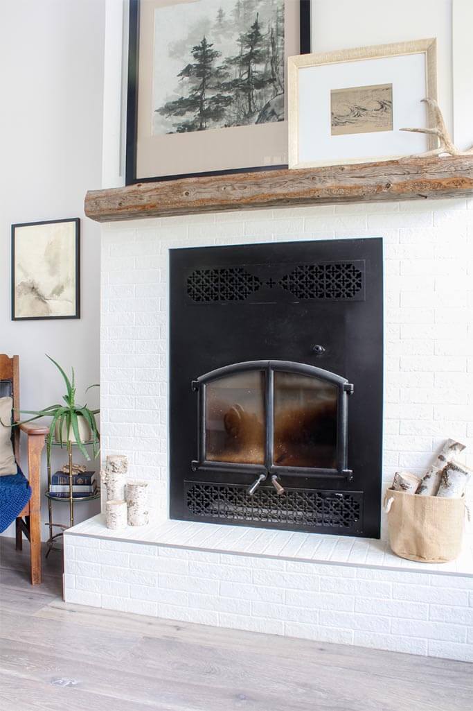 A bright living room with a fireplace and art on display.