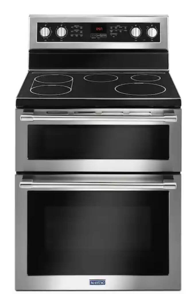 Stainless steel and black Maytag coil range on a white background.