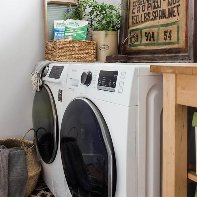 Laundry Room of Home with Sink Washing Machine Dryer Cabinets and