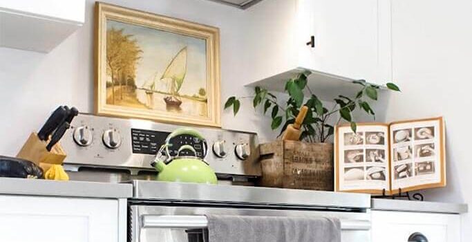 A bright kitchen with a stainless steel stove and rustic accessories.
