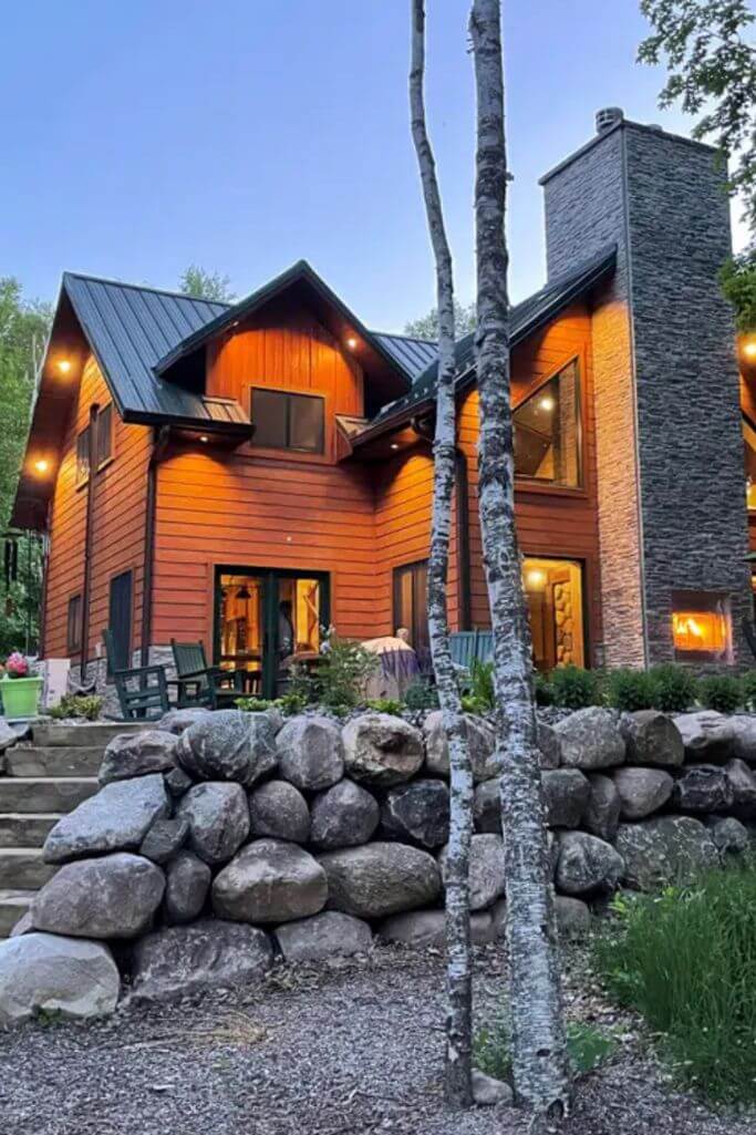 Exterior of a wood and stone precast concrete house.