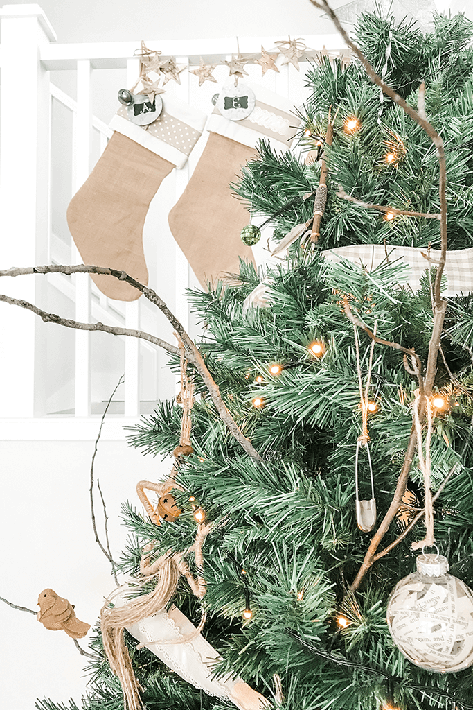 Closeup of a Christmas tree and two burlap stockings.