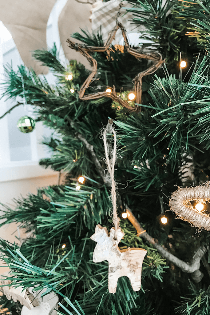 Closeup of a Christmas tree with nature-inspired ornaments.