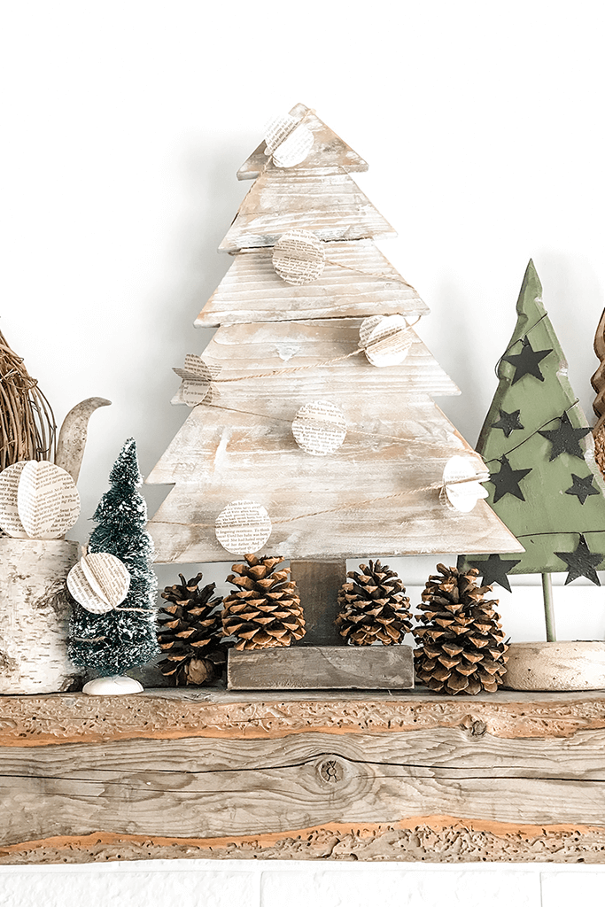 A wooden tree cutout on a holiday mantel.