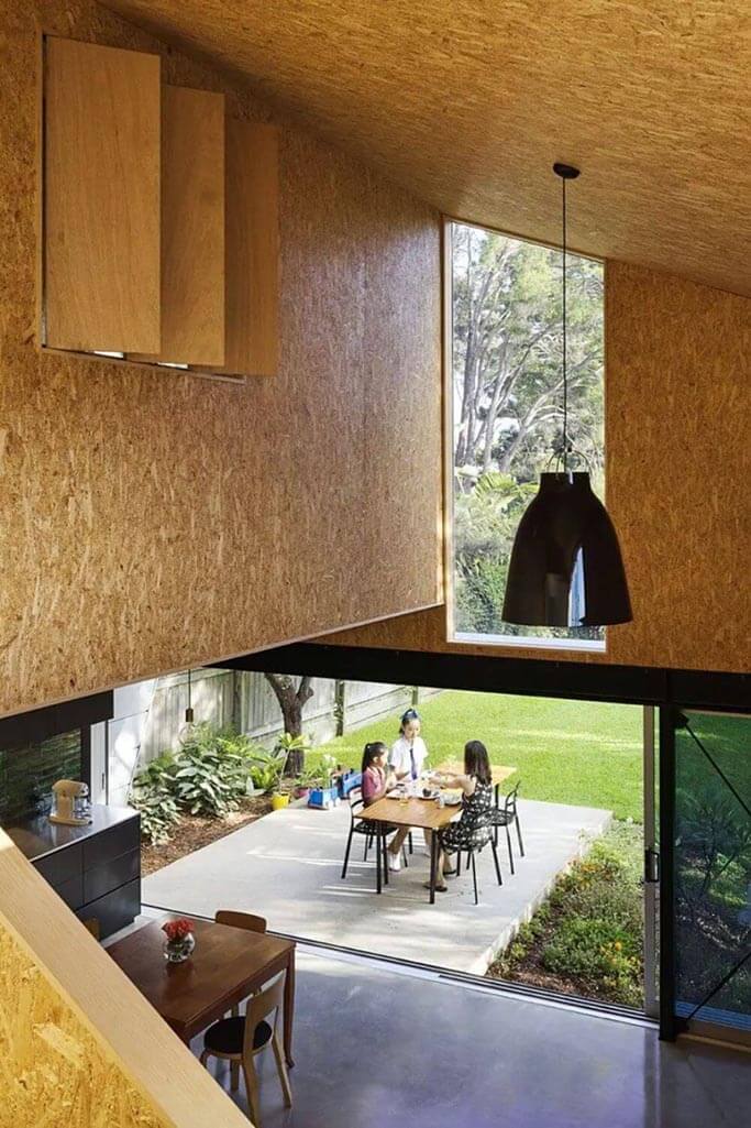 Interior of a home with wood walls and a large patio outside the space.