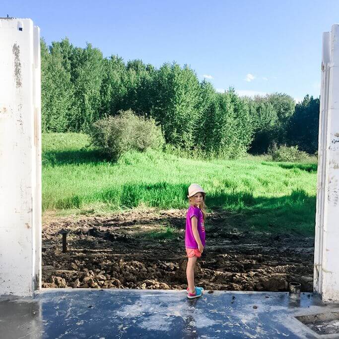 A young girl standing in an ICF basement under construction.
