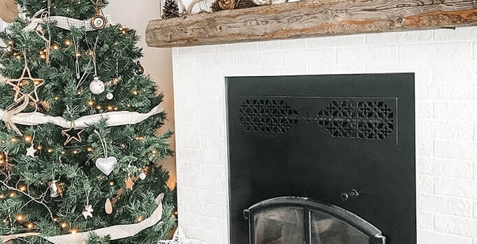 How to Decorate a Small Living Room for Christmas: 5 Simple + Sustainable Solutions A living room decorated with a Christmas tree and rustic ornaments.