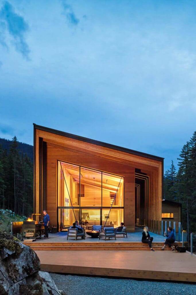 Wood home in a forest at nightfall.
