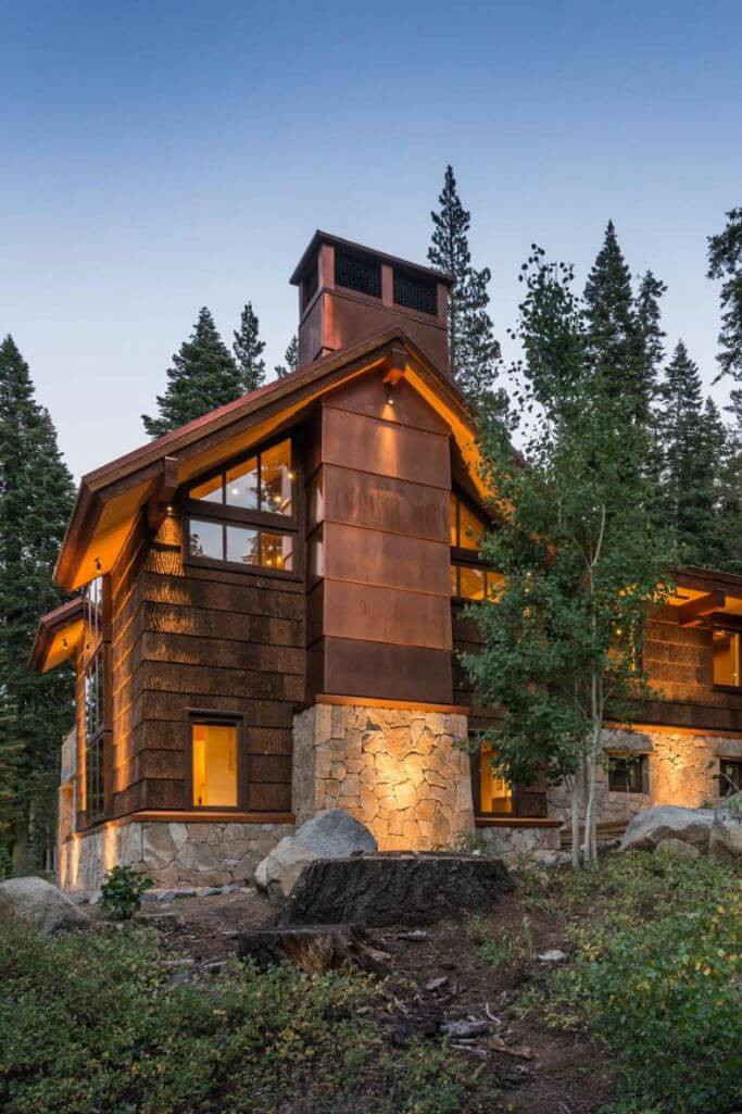 A large wooden home in a forest.
