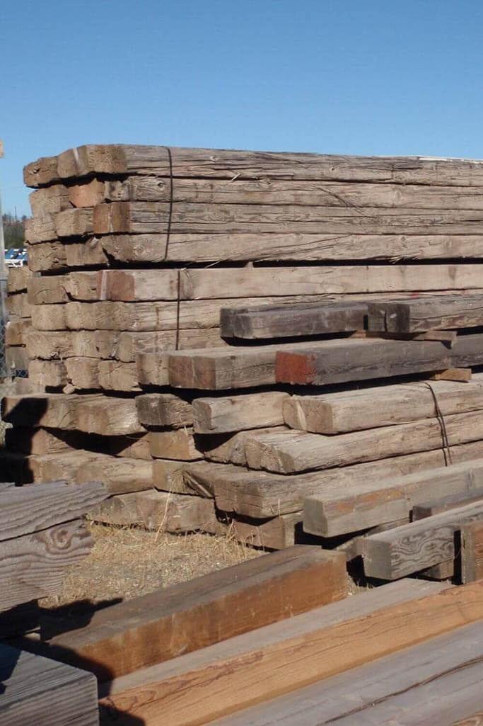 A pile of salvaged lumber outside.