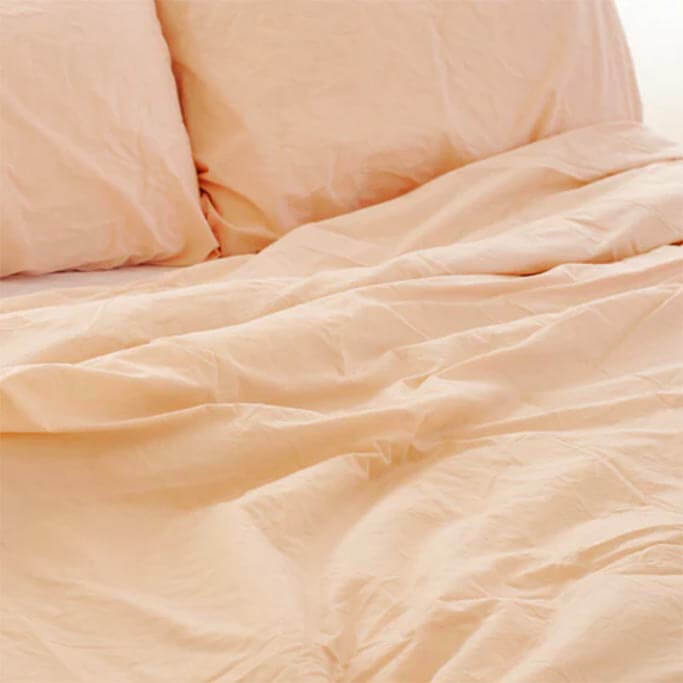 Closeup of a light pink sheet set.