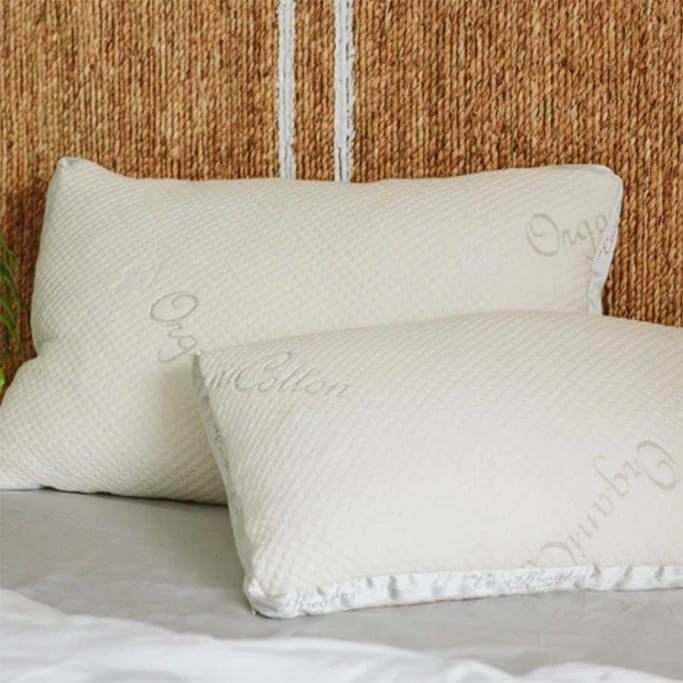 Two white pillows without pillowcases that have organic printed on them.