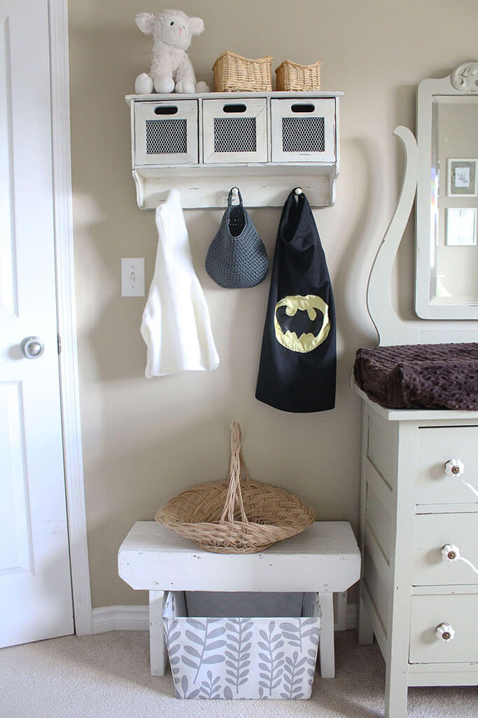 A green dresser and a white bench in a baby's room.