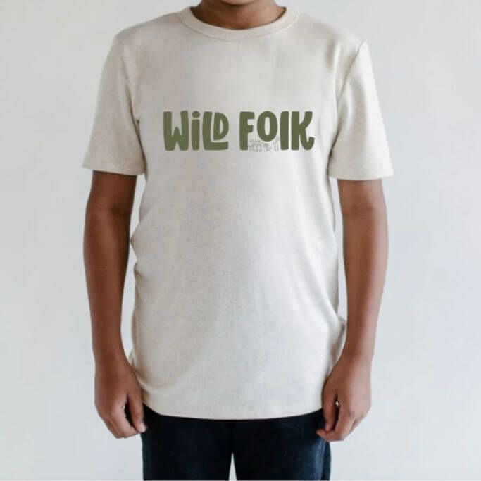 A child wearing a tee with text wild folk.