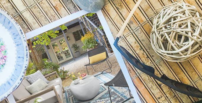 Where to Buy Sustainable Outdoor Furniture + 5 Patio Decor Ideas on a Budget A photo of a beautiful backyard patio sitting next to sunglasses, rocks and a floral plate.