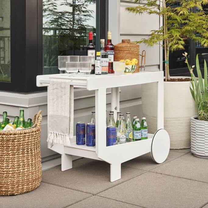 White bar cart on an outdoor patio.