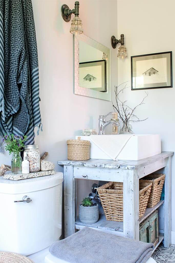 A rustic bathroom with handmade light fixtures.