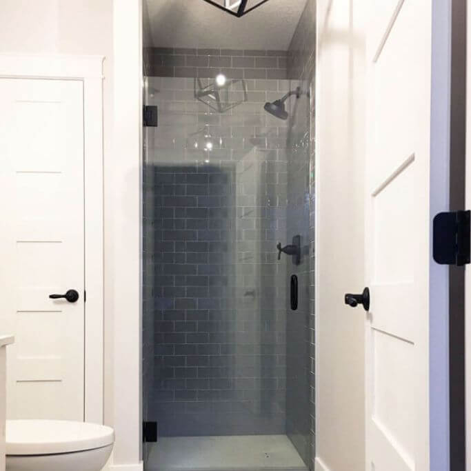 A clean, modern bathroom with black accents.